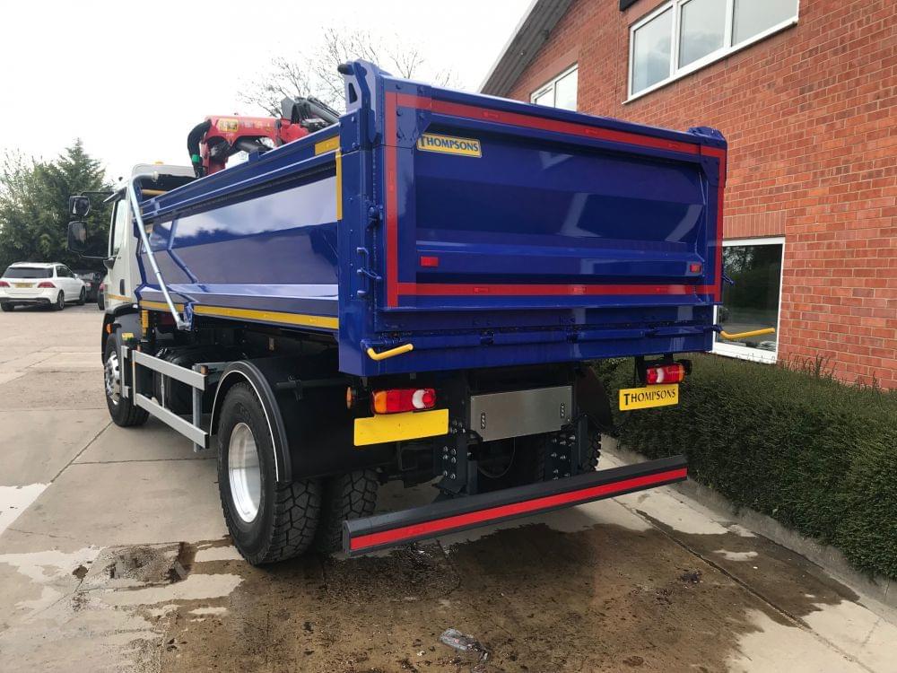 Black grab lorry with back up